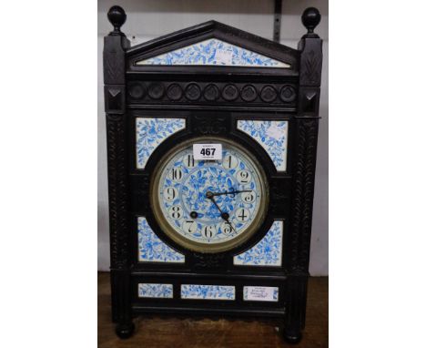 A late 19th Century Aesthetic Movement ebonised cased and decorative blue and white ceramic panel inset cased mantel clock wi