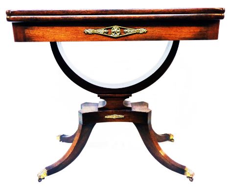 A 34" late Regency mahogany and cross banded fold-over card table with applied cast brass detailing, set on an open bow patte
