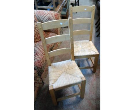 A set of six modern blonde wood framed ladder back dining chairs with woven rush seats, set on square supports