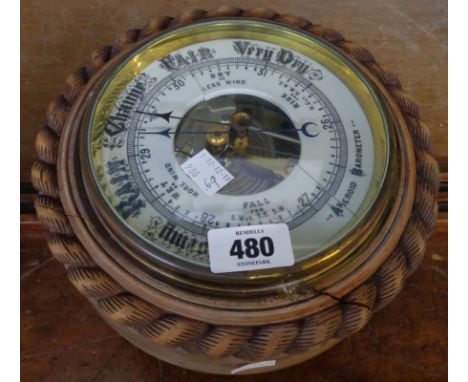 A late 19th Century oak cased wall barometer with damaged rope twist border case and cracked ceramic dial with visible aneroi