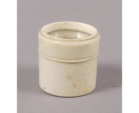 A GEORGE III PATCH BOX, of cylinder form, in turned bone, with mirrored threaded top, approximately 33mm x 33mm