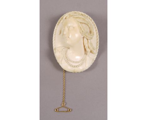 A VICTORIAN IVORY BROOCH, oval, carved in relief with head and shoulders portrait of Ceres, Goddess of Earth, within a rope t