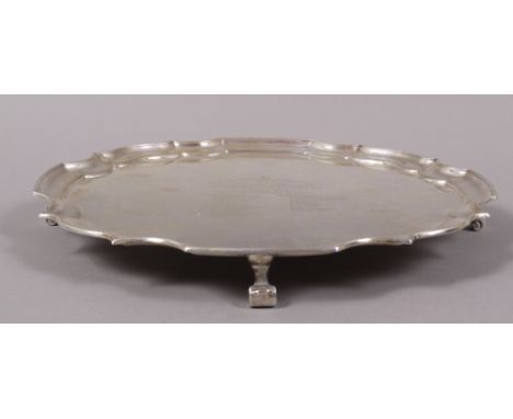 MASONIC INTEREST: A SILVER PRESENTATION SALVER, with piecrust rim and three scroll feet, engraved with inscription to 'Bro.E.