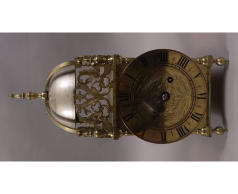 A BRASS CASED LANTERN STYLE MANTEL CLOCK, 20th century, with single bell, pierced frieze, broad chapter ring and single train