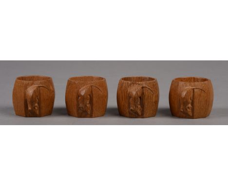A SET OF FOUR ROBERT THOMPSON OF KILBURN 'MOUSEMAN' OAK NAPKIN RINGS, each of octagonal form with large mouse signature, each
