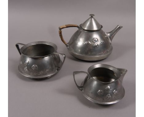 ARCHIBALD KNOX FOR LIBERTY, A THREE PIECE PEWTER TEA SET,  c.1910, each piece of conical form with angular handles, decorated