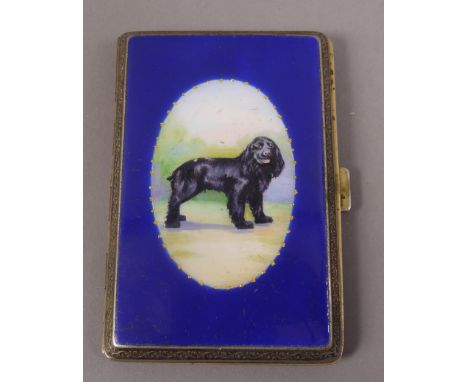 AN EARLY 20TH CENTURY ENAMELLED CIGARETTE CASE, black Cocker Spaniel standing within an oval landscape and surround of blue a