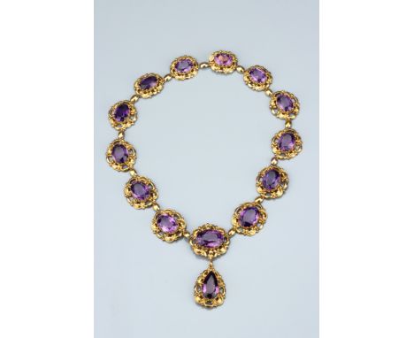 A Mid-Victorian Amethyst Riviere Necklace, with pendant drop, comprising thirteen graduated oval cut amethysts and suspending