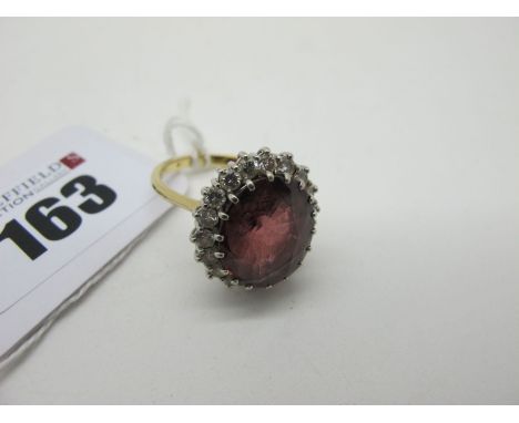 A Large Cluster Ring, oval claw set centre, within diamond claw set boarder, between tapered shoulders, hallmark rubbed (fing