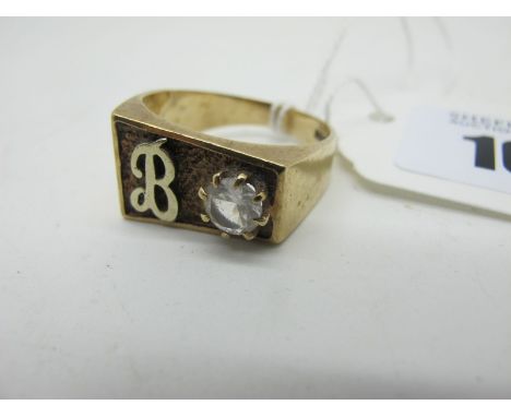 A 9ct Gold Gent Signet Style Ring, of rectangular shape, initialled with claw set highlight, within textured panel, between w