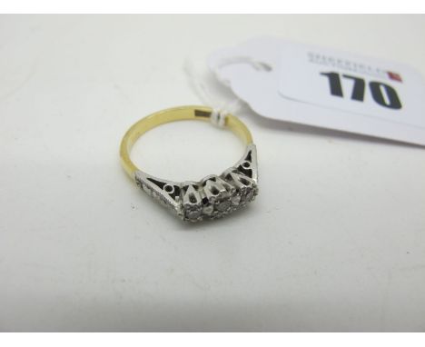 A Three Stone Ring, illusion set between textred shoulders, stamped "18ctPlat" (finger size M1/2) (2.6grams). 