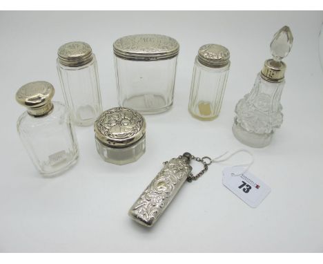 Assorted Hallmarked Silver Topped Glass Dressing Table Jars and Scent Bottle, (various makers and dates) (dents), together wi