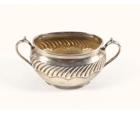 Late Victorian silver good gauge oval sugar basin with gadrooned swags and 2 scroll handles, on a raised foot, by Henry Strat