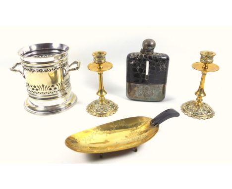 A pair of brass candlesticks in the ecclesiastical taste, a silver plated bottle coaster, a silver plated snake skin effect h