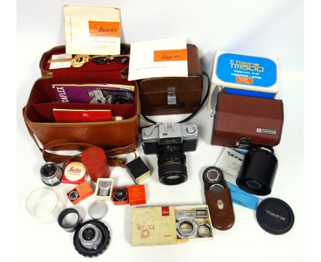 A Nikkorex camera with zoom in original leather case, two Leica lenses, a Zeiss gauge, Leitz accessories, instruction booklet