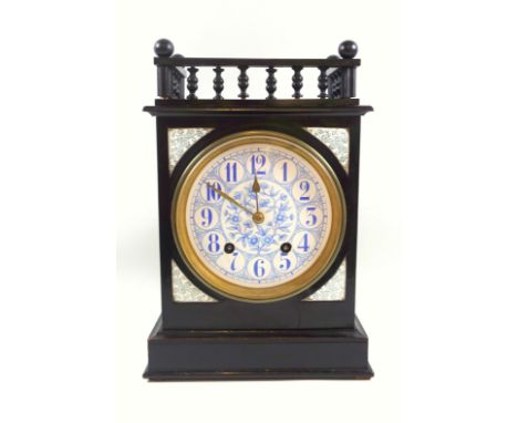 A late Victorian ebonised mantel clock, with galleried to over a blue floral printed dial with Arabic numerals to a twin barr