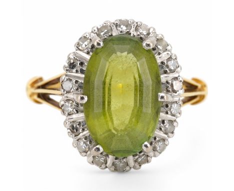 An 18ct, peridot and diamond set oval cluster ring, size K/L, gross weight 4.1 grams. Condition - poor to fair