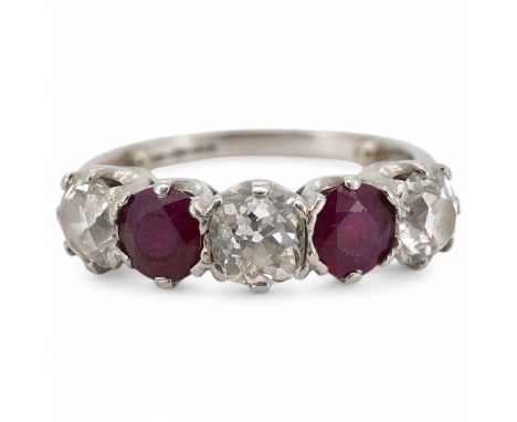 A ruby and diamond five-stone ring, set with an alternating sequence of antique cushion-shaped diamonds totalling approximate