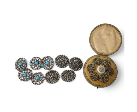 An Edwardian cased set of 6 cut steel buttons with central floral motifs, 20mm, a paste inset ceramic button, a set of 4 cut 