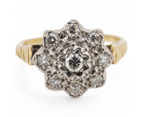 An 18ct and illusion set diamond cluster ring, size M/N, gross weight 3.6 grams. Condition - fair