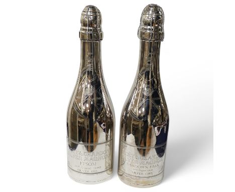 A near pair of Elizabeth II silver presentation magnum bottles by Garrard &amp; Co inscribed 'Moet &amp; Chandon Silver Magnu