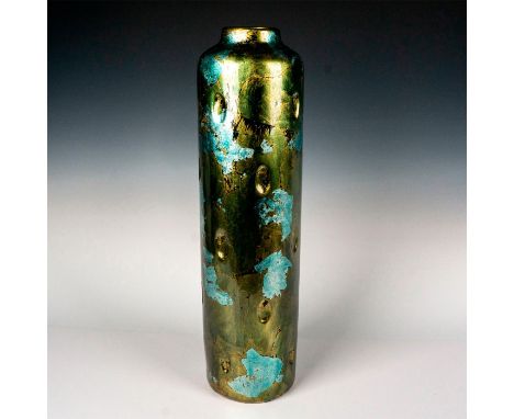 Tall decorative vase with cylindrical shape, flat rim, and oval shaped divots impressed through out body of piece. Metallic v