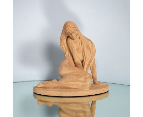 Elegant and feminine sculpture modeled as a seated nude woman with long flowing hair. Light terracotta finish and semicircle 