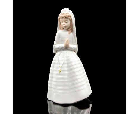 Dressed in all white with rosary. Nao by Lladro backstamp. 02000236. Artist: Jose' RoigIssued: c.1992Dimensions: 5"L x 3.5"W 