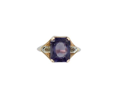 An elegant geometric design ladies ring with rectangular sapphire and two diamonds. Sapphire changes color from light blue to