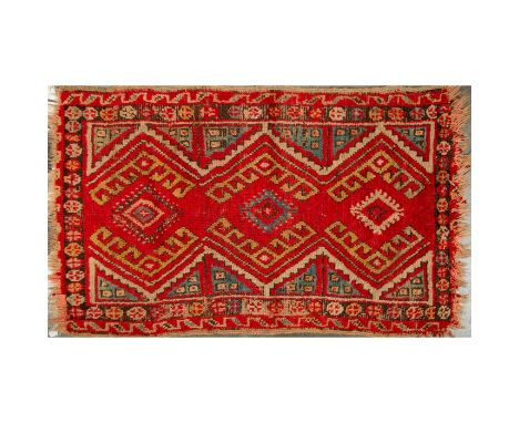 Flatwoven rug with intricate geometric patterns in red, yellow, light blue, and cream colors; fringed edges. Dimensions: 31"L