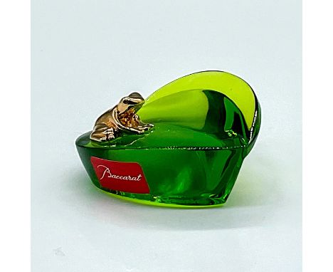 A peridot-green leaf shaped crystal with a tiny gold-plated rog resting on top. Baccarat markings on the base and side. This 