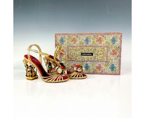 Exquisite pair of sandals delicately crafted from gold-hued leather. Features gold tone cage heels that are filled with lovel