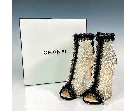 A lovely pair of open-toe evening booties with white and black mesh exterior and white quilted interior. Features the CC desi