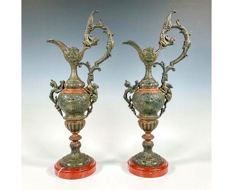 Two magnificent neo-renaissance sculpturesque ewers with dragon decoration. The pitcher rests on a marble base. Issued: c. 18