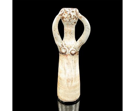 Figurative art pottery vase modeled as a woman with her arms upraised and hands clutching the sides of her head. She has a co