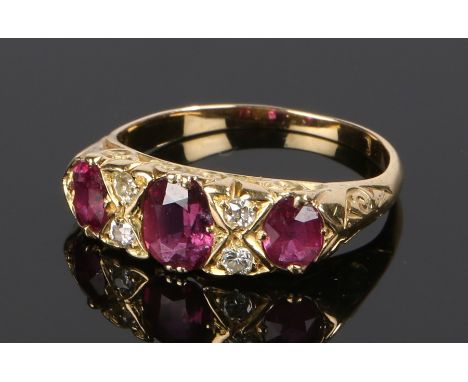 Ruby and diamond set ring, with three rubies and four diamonds to the head, ring size O 1/2