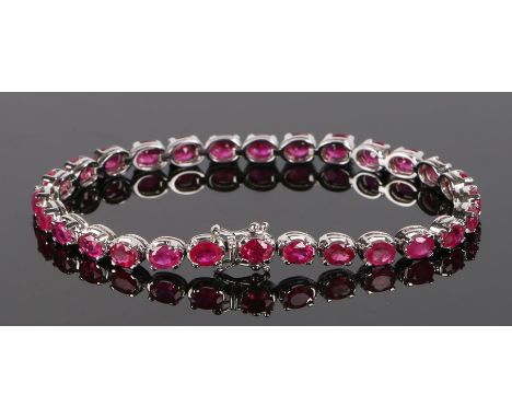 18 carat white gold &amp; ruby set bracelet, with a row of thirty-one rubies at an approximate total of 12.34 carats, 18cm lo