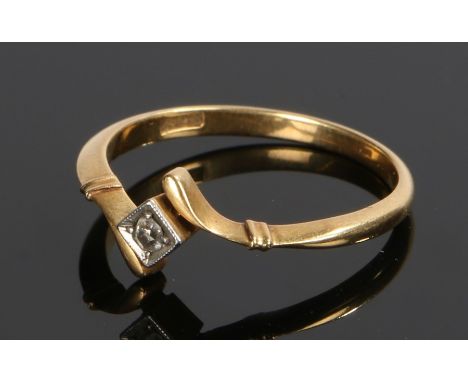 18 carat gold diamond set ring, the white metal square head with a central diamond and cross over shoulders, ring size N