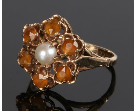 9 carat gold and pearl ring, the head formed as a flower with central pearl surrounded by orange stones, ring size P