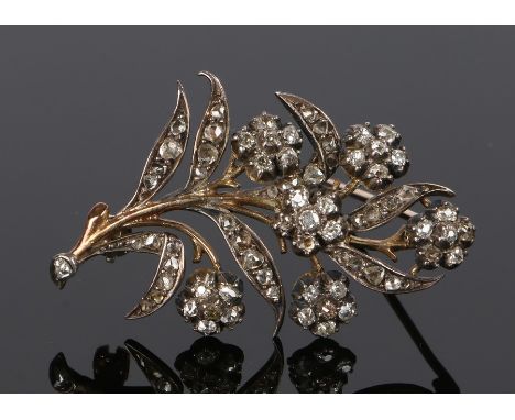 Diamond set brooch, in the form of flowers, set with diamonds to the leaves and heads, 42mm high From the estate of the Late 