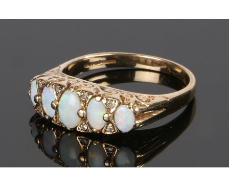 9 carat gold opal and diamond set ring, with five opals and eight diamond divides, ring size S