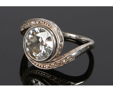 Beautiful platinum and diamond set ring, the round cut diamond at approximately 2.7 carats with arched shoulders surrounding 