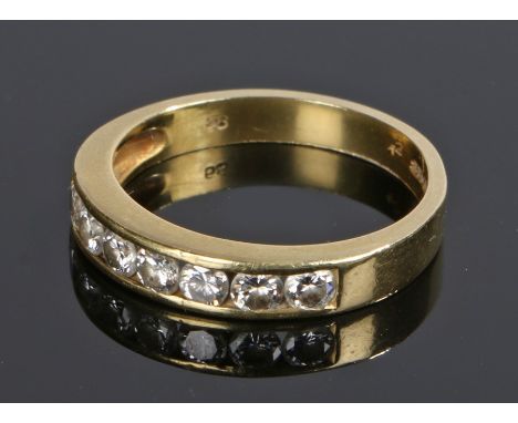 18 carat gold half eternity ring, with a row of seven round cut diamonds totalling 0.58 carat, ring size M 1/2