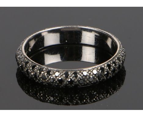 18 carat gold black diamond eternity ring, with three rows of black diamonds to the shank, the black diamonds at a total of 1