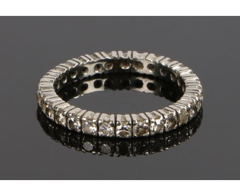 Platinum and diamond set eternity ring, set with twenty nine round cut diamonds tot eh shank, ring size O