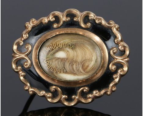 19th Century Mourning brooch, with a central hair locket with black enamel and C scroll edge, 32mm diameter 