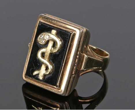 Poison ring, in yellow metal with a coiled snake hinged front enclosing a compartment, ring size R