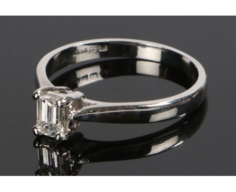 Platinum and diamond solitaire ring, the emerald cut diamond at approximately 0.4 carat, ring size P