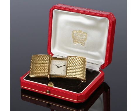 Cartier gold purse timepiece, the signed dial with dash hours, pull open case with French gold owl marks and strut to the bac
