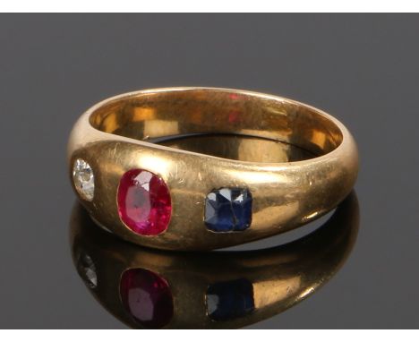 Victorian gold ruby sapphire and diamond set ring, with a central ruby flanked by a diamond and sapphire, 4.2 grams, ring siz